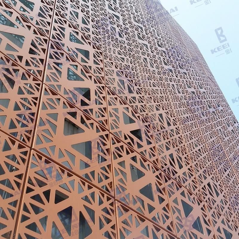 Curved perforated copper-toned ACP screen wrapping a commercial tower facade