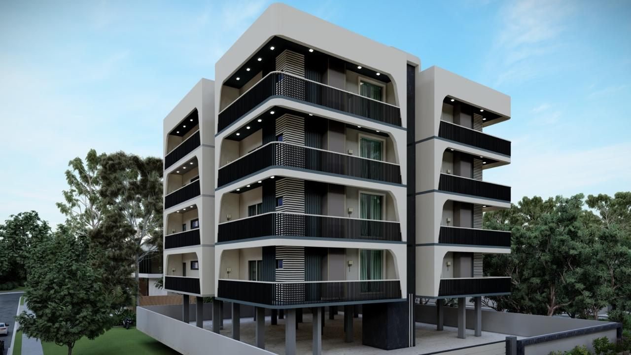 Modern residential block exterior with recessed balconies and dark vertical louvre screens